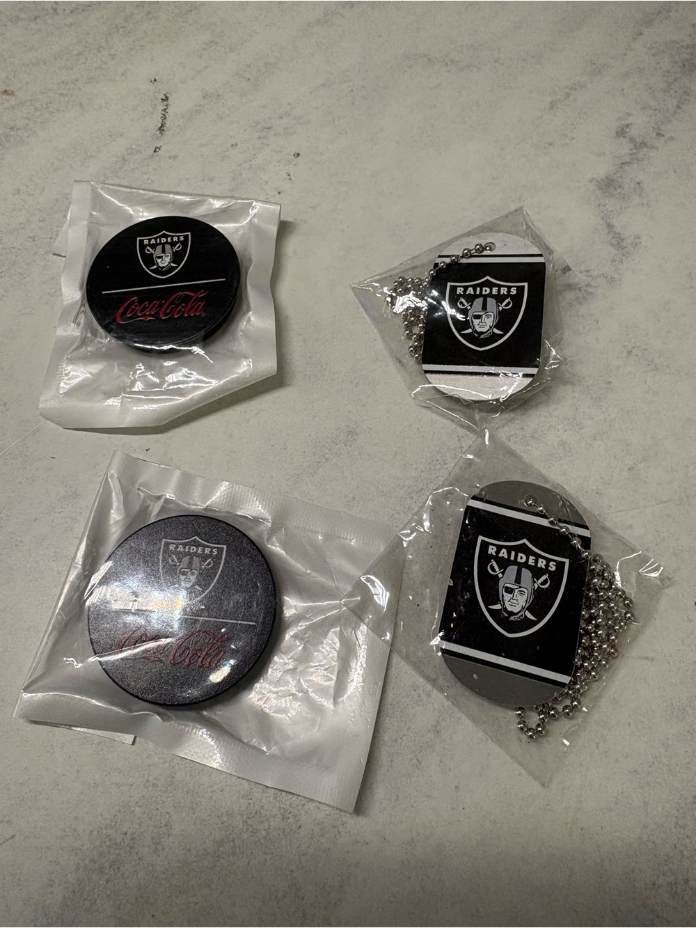 Raiders Black Logo Button and Dog Tag Lot